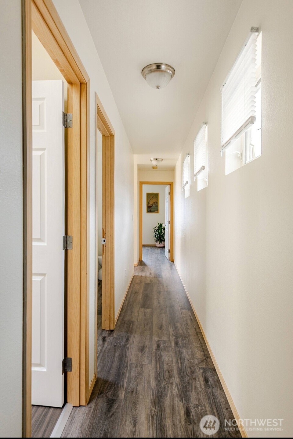 10047 17th Avenue Southwest Seattle, WA 98146 - Photo 17 of 27 a view of a hallway with wooden floor and staircase