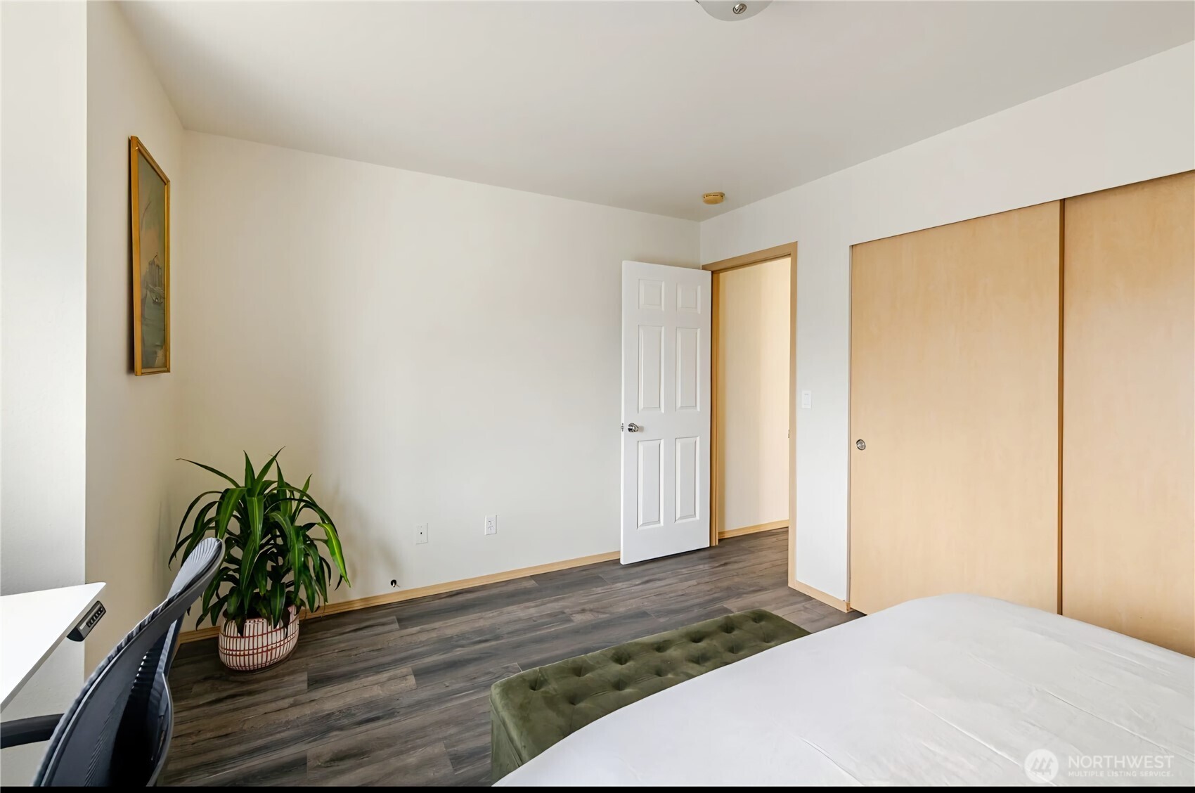 10047 17th Avenue Southwest Seattle, WA 98146 - Photo 19 of 27 a bedroom with a bed and wooden floor