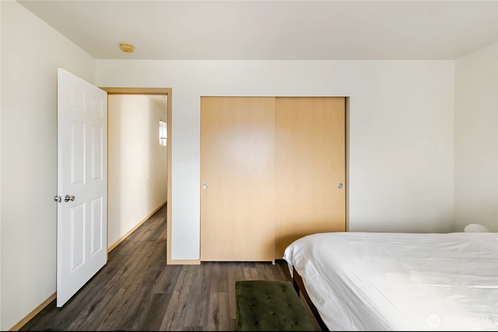 10047 17th Avenue Southwest Seattle, WA 98146 - Photo 20 of 27 a bedroom with a bed and wooden floor