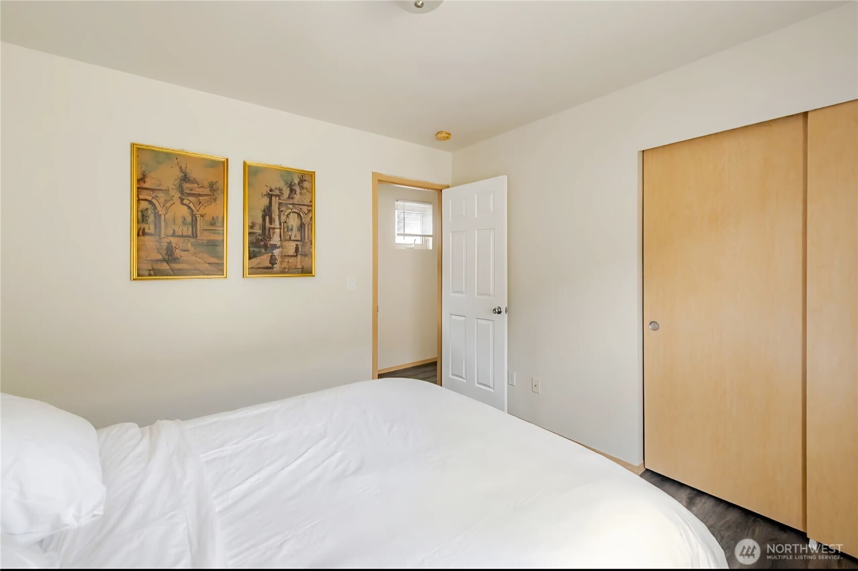 10047 17th Avenue Southwest Seattle, WA 98146 - Photo 22 of 27 a bedroom with a bed and a window