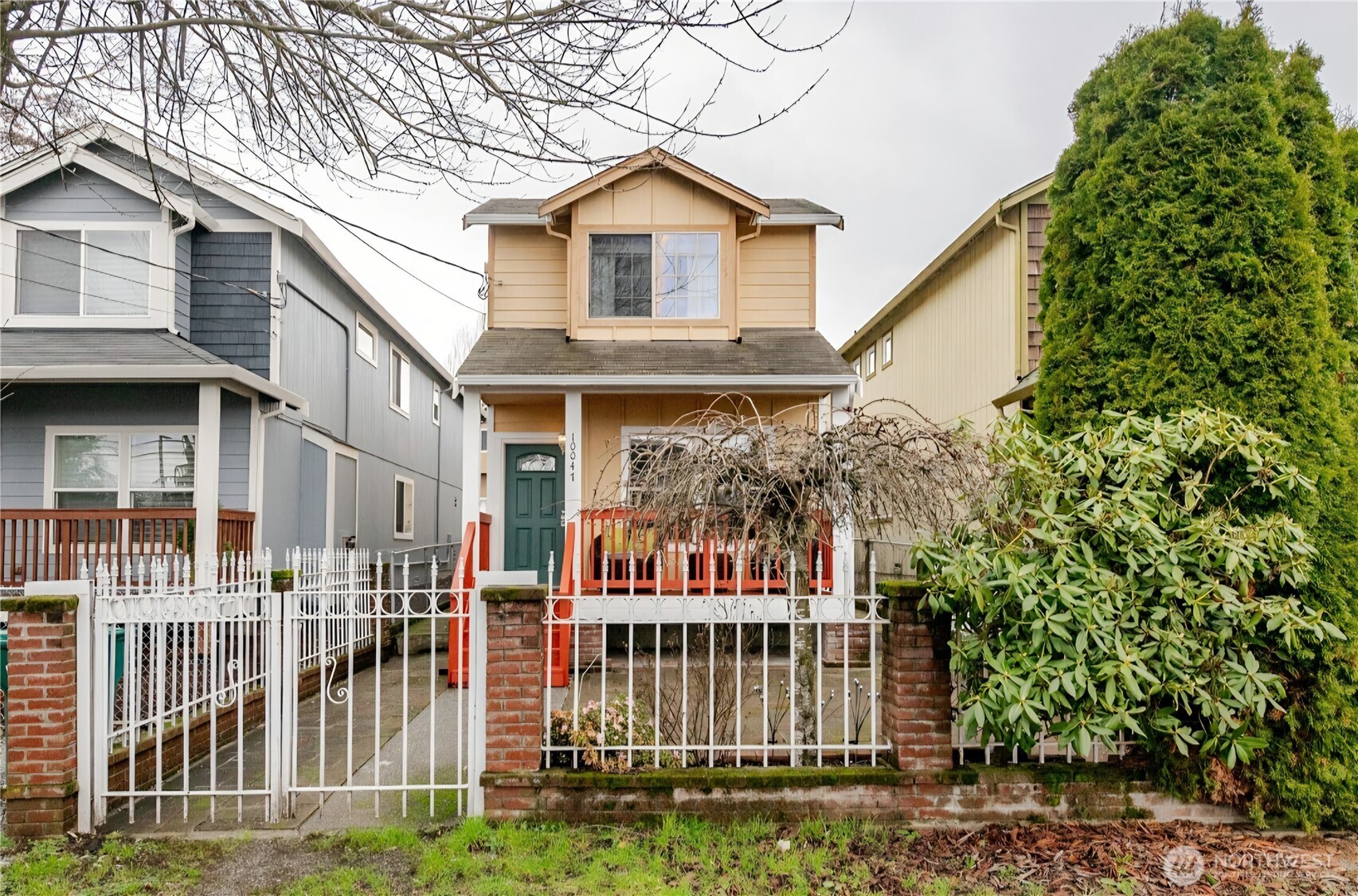 10047 17th Avenue Southwest Seattle, WA 98146 - Photo 27 of 27 a view of a brick house with large windows and a small yard