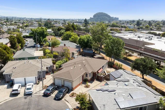 an aerial view of a house with a yard garage and mountain view in back