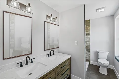 a bathroom with a toilet sink and mirror