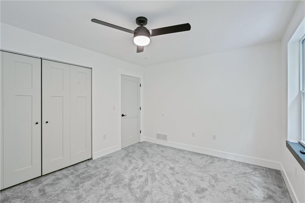 1102 Spring Garden Avenue Pittsburgh, PA 15212 - Photo 17 of 25 an empty room with a ceiling fan and a window
