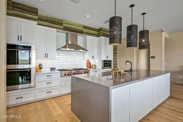 a kitchen with stainless steel appliances granite countertop a stove and a sink