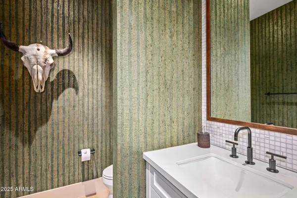 a bedroom with a large bed couch and a large window