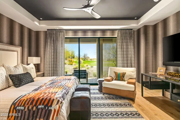 a bedroom with bed and wooden floor