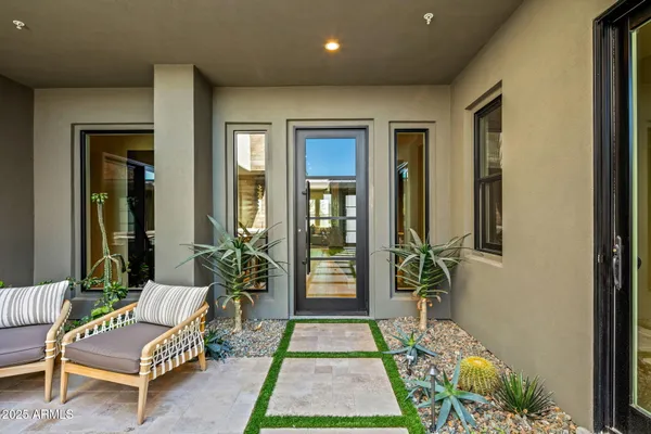 a living room with a couch and a potted plant