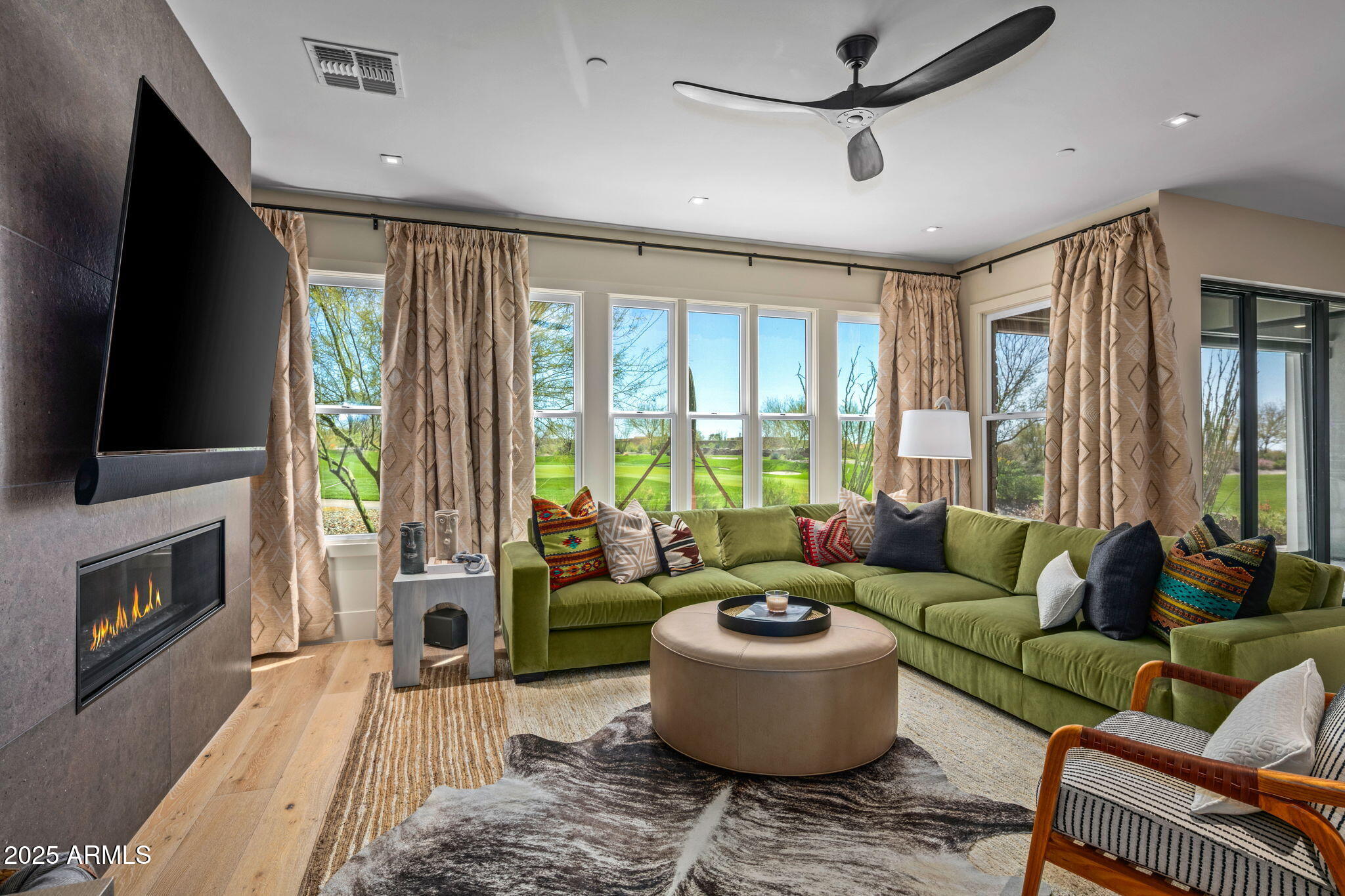 37200 North Cave Creek Road, Unit 1126 Scottsdale, AZ 85262 - Photo 6 of 28 a living room with furniture a flat screen tv and a fireplace