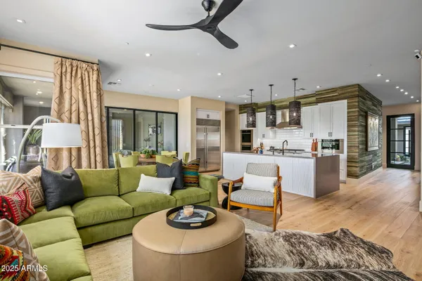 a living room with furniture a large window and a flat screen tv