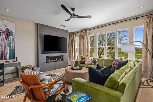 a kitchen with stainless steel appliances kitchen island granite countertop a refrigerator a oven and a wooden floors