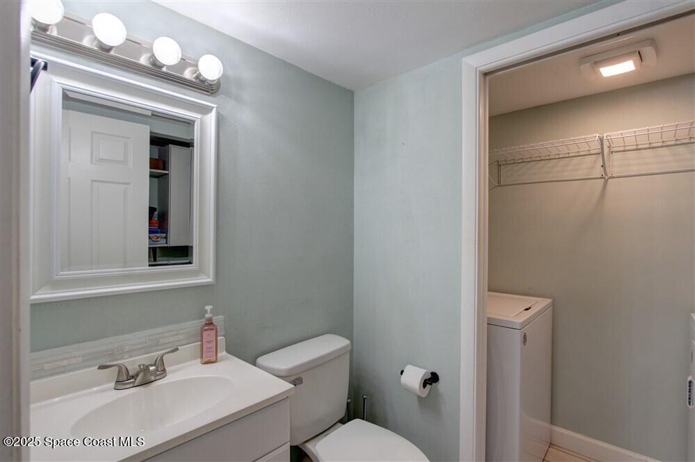 1717 Patty Circle Northeast Palm Bay, FL 32905 - Photo 15 of 35 a bathroom with a sink vanity mirror and toilet