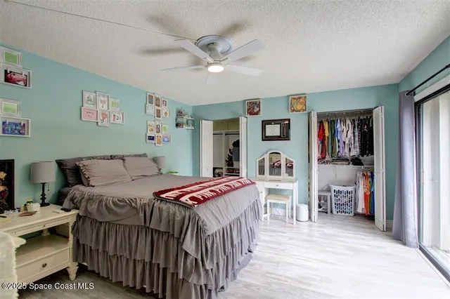 a bedroom with bed and wooden floor