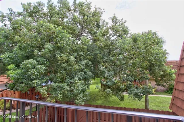 a view of a yard from a balcony