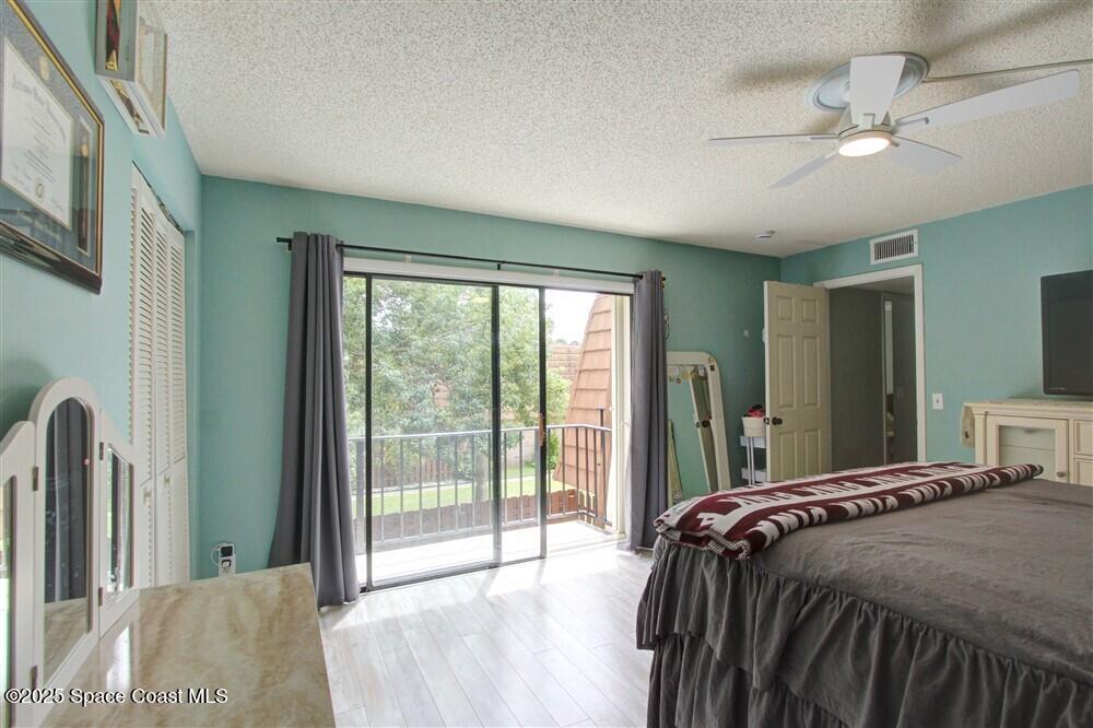 1717 Patty Circle Northeast Palm Bay, FL 32905 - Photo 23 of 35 a bedroom with a large bed and a large window