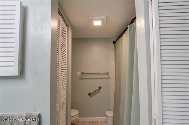 a bathroom with a shower and a toilet