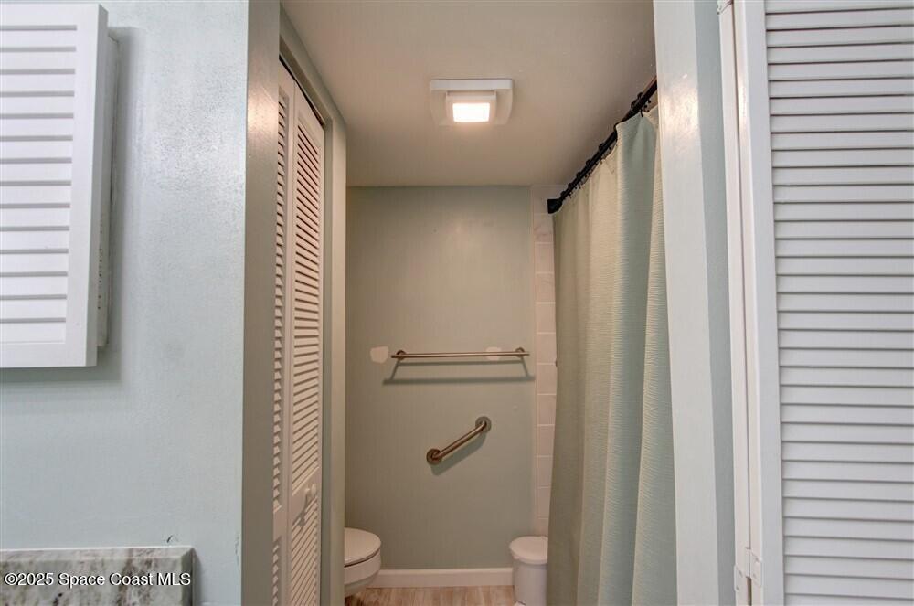 1717 Patty Circle Northeast Palm Bay, FL 32905 - Photo 26 of 35 a bathroom with a shower and a toilet