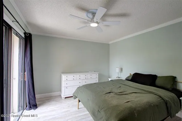 a bedroom with a large bed and a large window