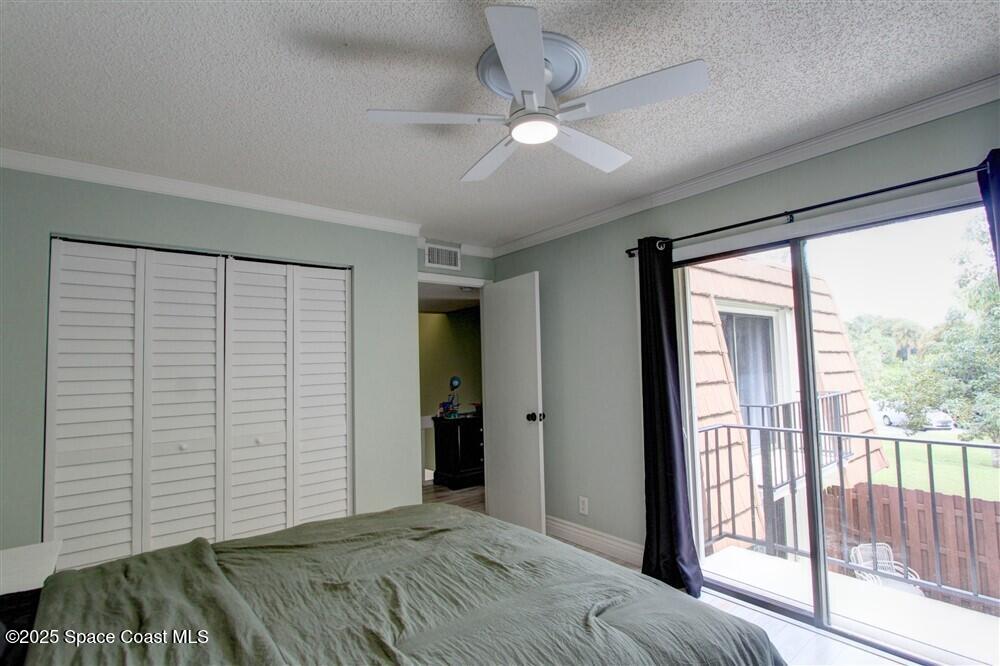1717 Patty Circle Northeast Palm Bay, FL 32905 - Photo 29 of 35 a bedroom with a bed and a large window