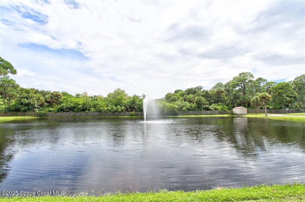 1717 Patty Circle Northeast Palm Bay, FL 32905 - Photo 30 of 35 a view of a lake with houses in the back