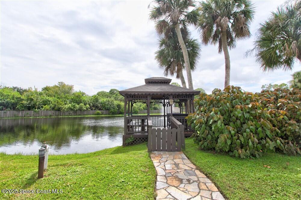 1717 Patty Circle Northeast Palm Bay, FL 32905 - Photo 32 of 35 a view of a lake with a garden