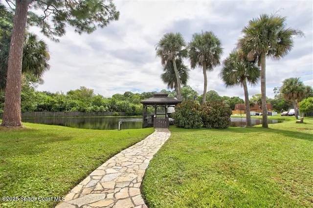 a view of a swimming pool with a yard