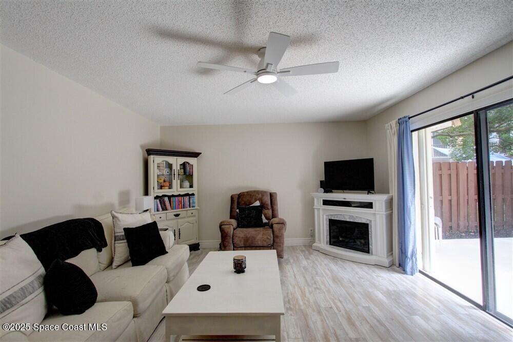 1717 Patty Circle Northeast Palm Bay, FL 32905 - Photo 4 of 35 a living room with furniture and a flat screen tv