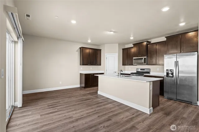 a kitchen with stainless steel appliances a refrigerator and a microwave