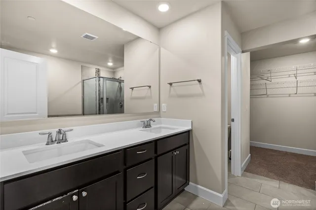 a bathroom with a double vanity sink a and mirror