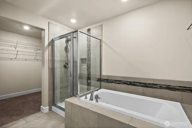 a bathroom with a bathtub and a shower