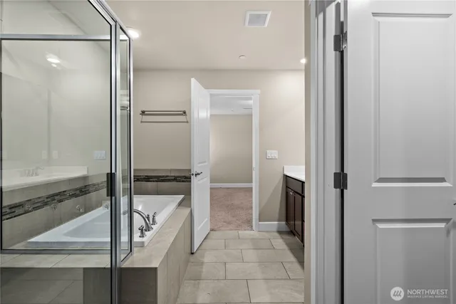 a bathroom with a glass shower door and a mirror