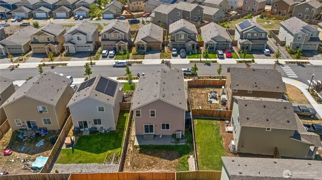an aerial view of multiple houses with yard