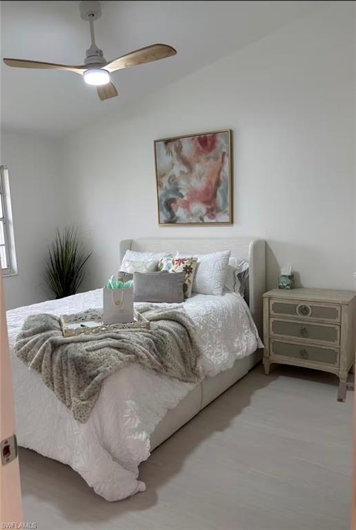 14993 Rivers Edge Court, Unit 246 Fort Myers, FL 33908 - Photo 6 of 23 a bedroom with a bed and a chandelier