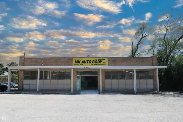 a front view of a building with a garden