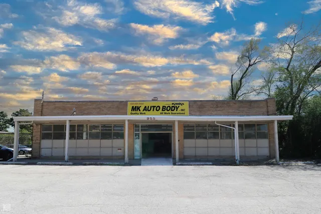 a front view of a building with a garden