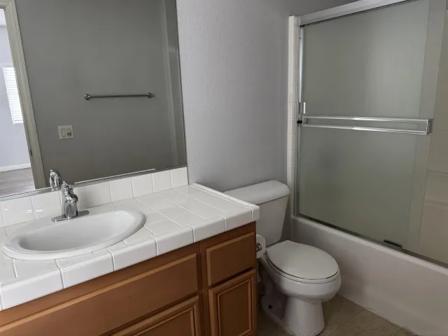 a bathroom with a sink a toilet and vanity