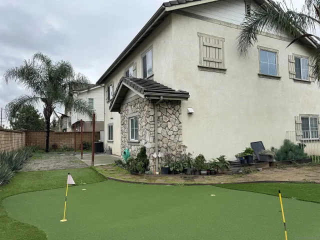 a view of a house with a swimming pool and a yard