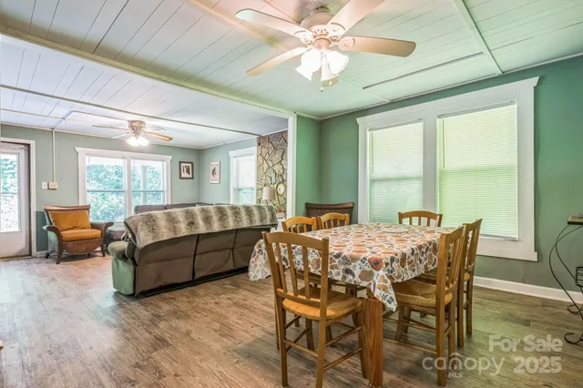 a view of a dining room with furniture window and wooden floor