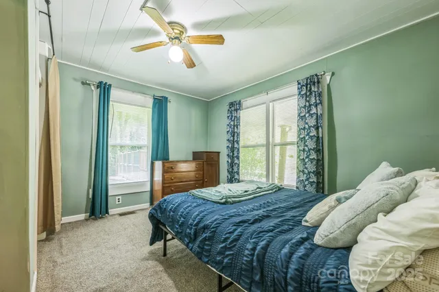 a bedroom with a large bed and a chandelier