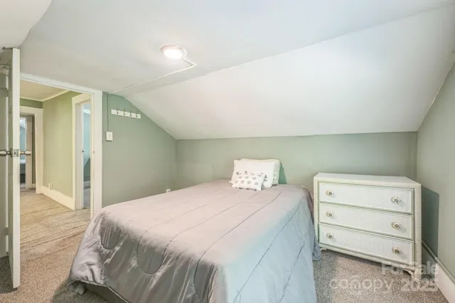 a bedroom with a bed and a mirror