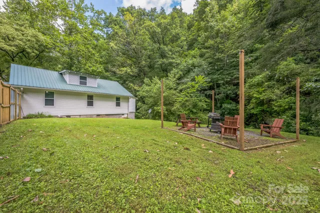 a view of a house with backyard and sitting area