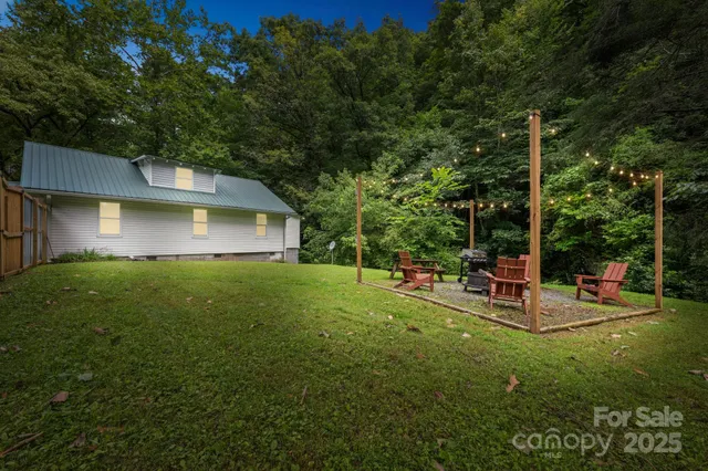 a view of a house with backyard and sitting area
