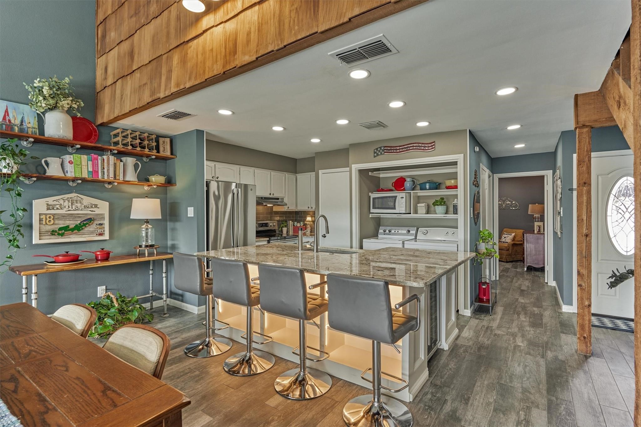 1 April Point Drive South Montgomery, TX 77356 - Photo 11 of 45 A closer look at the island features under counter lighting at the bar side with shelving for storage & display.