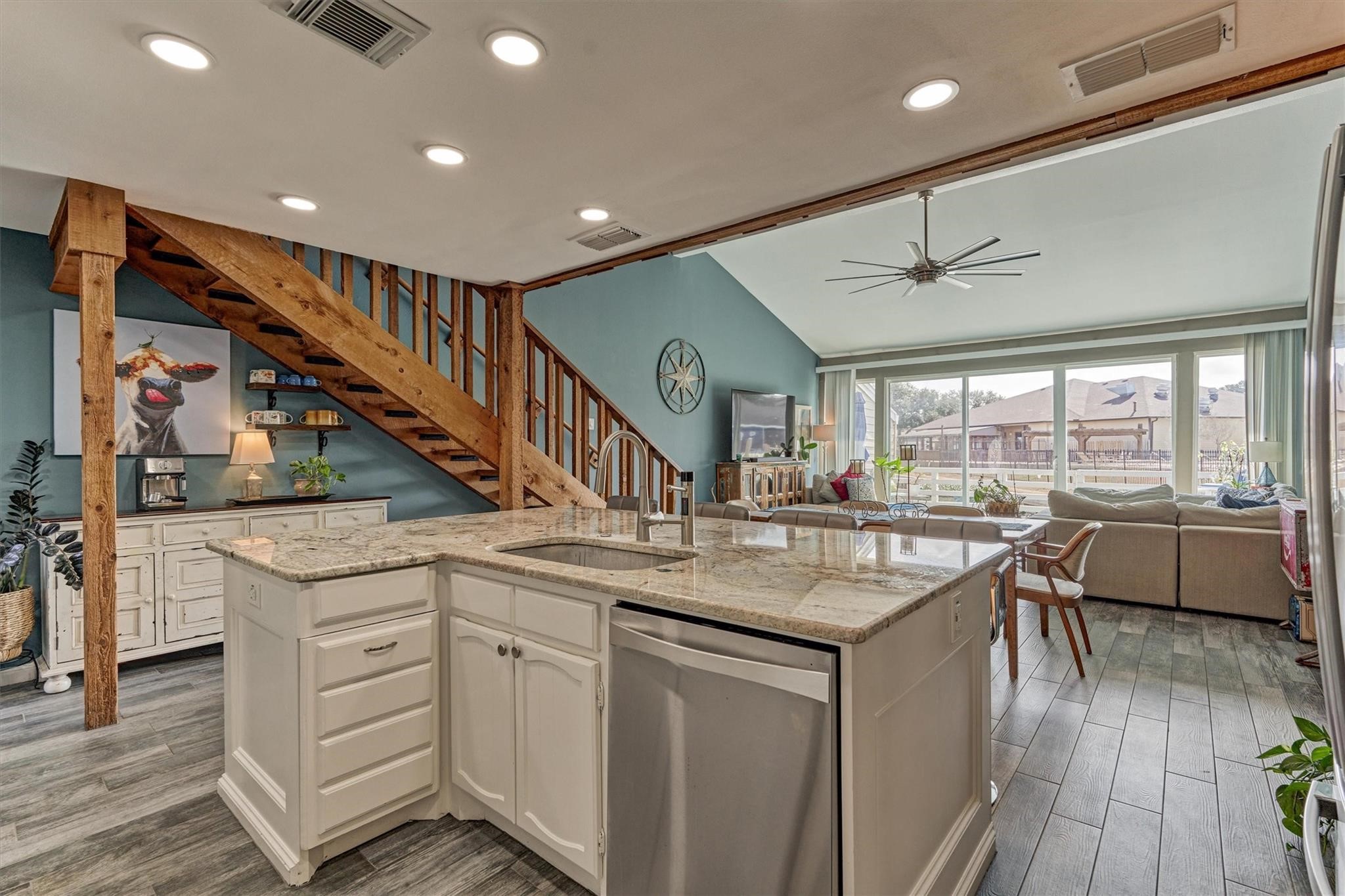 1 April Point Drive South Montgomery, TX 77356 - Photo 16 of 45 Looking back from the kitchen, the dining and living spaces flow beautifully together, anchored by a rich wood-stained stairway and coordinating railing.