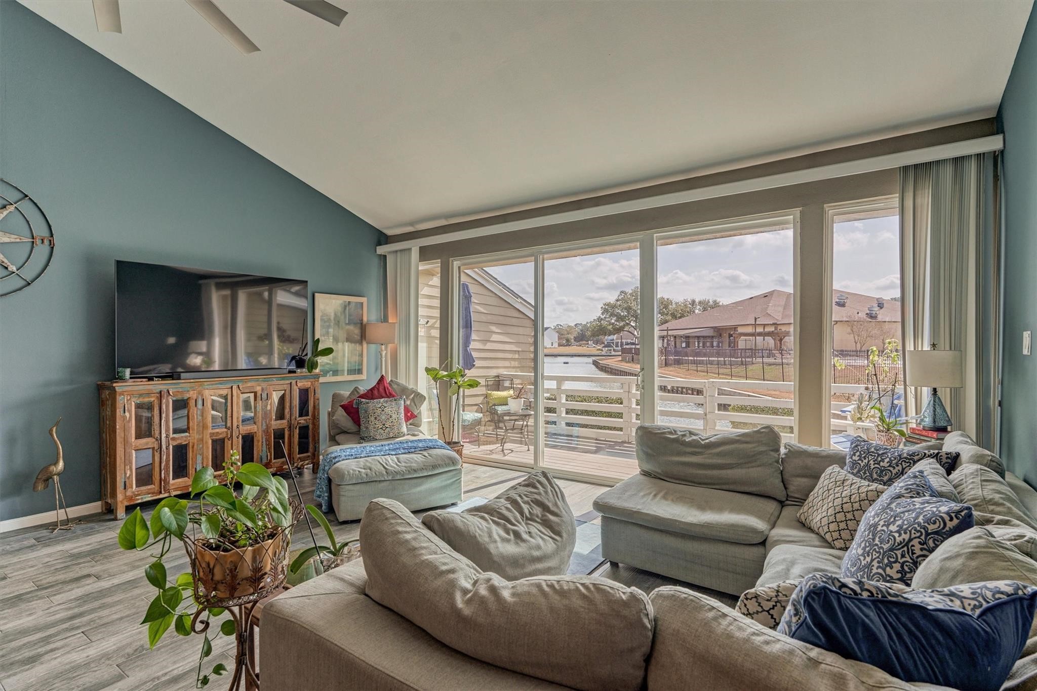 1 April Point Drive South Montgomery, TX 77356 - Photo 19 of 45 A wall of windows frames beautiful views of the lake beyond.