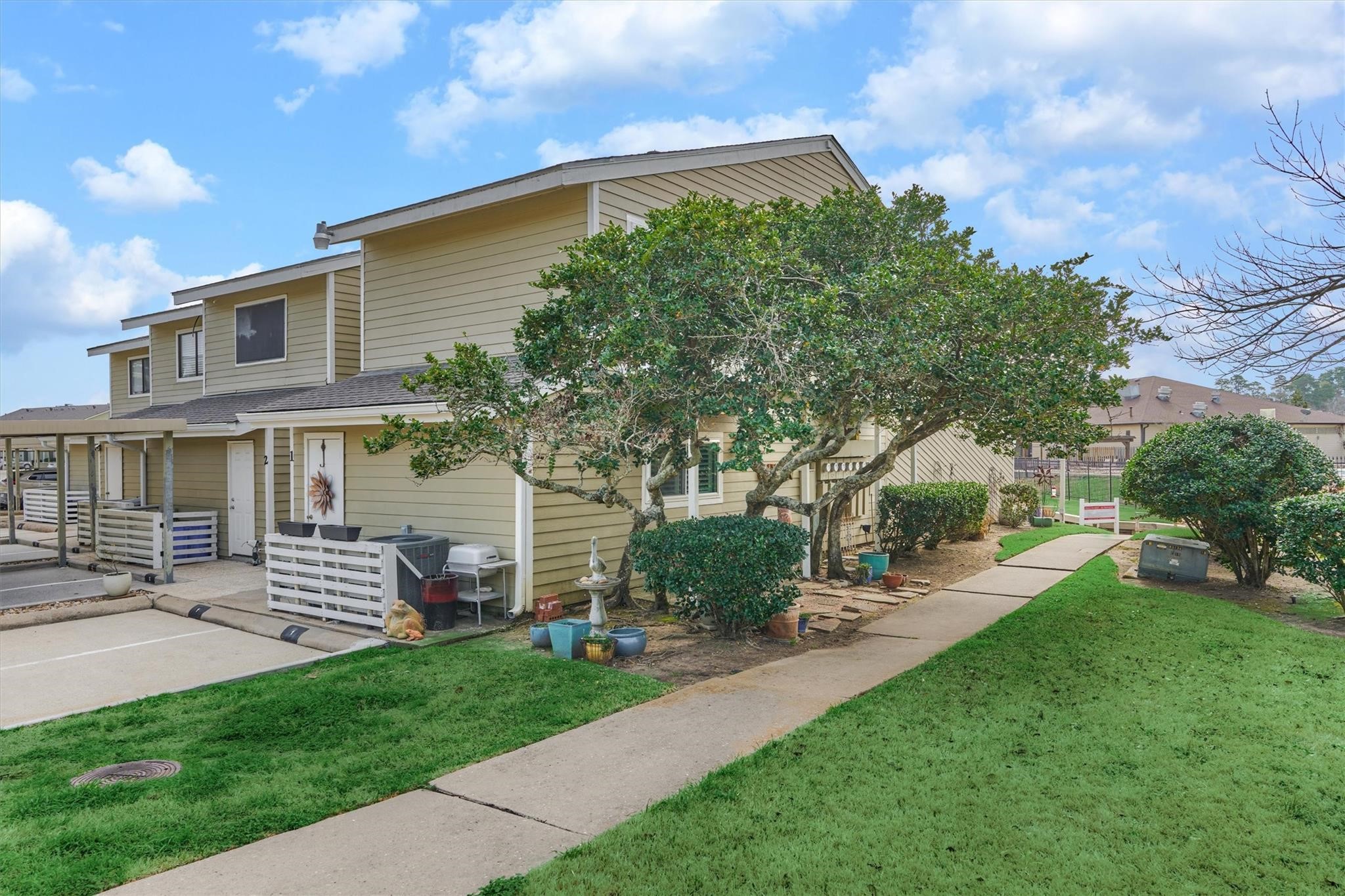 1 April Point Drive South Montgomery, TX 77356 - Photo 4 of 45 A sidewalk to the lakefront area is for resident use. Enjoy a side courtyard that other townhomes in this area don't have!