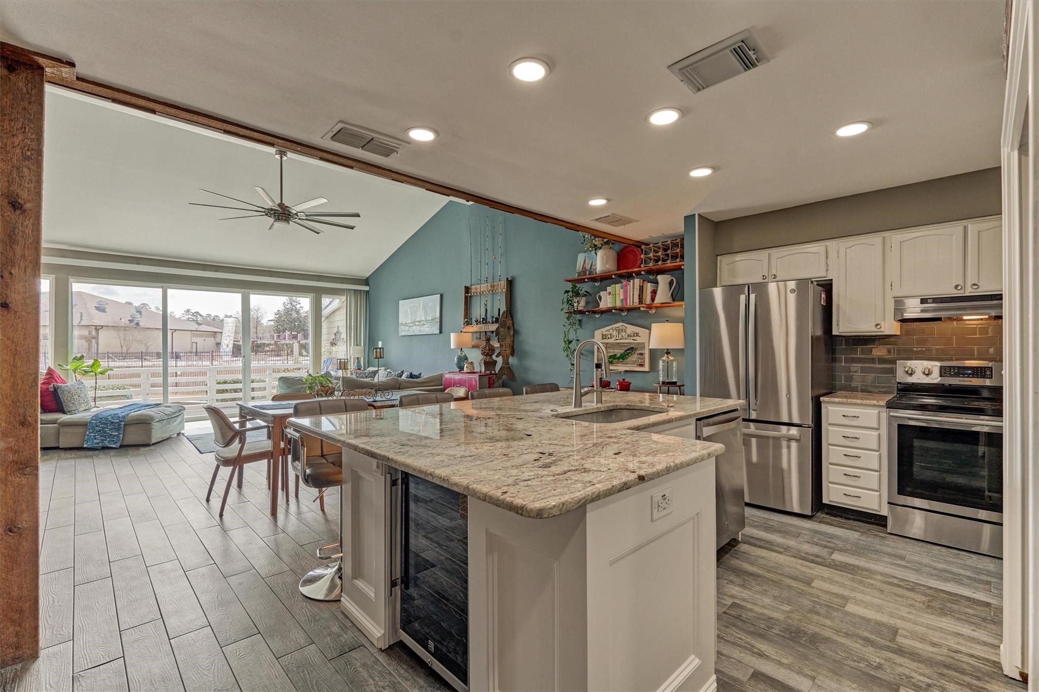 1 April Point Drive South Montgomery, TX 77356 - Photo 8 of 45 The owners removed kitchen cabinetry blocking the water view and remodeled w/ high-end granite countertops, stainless appliances, recessed lighting, and space for a wine/beverage refrigerator