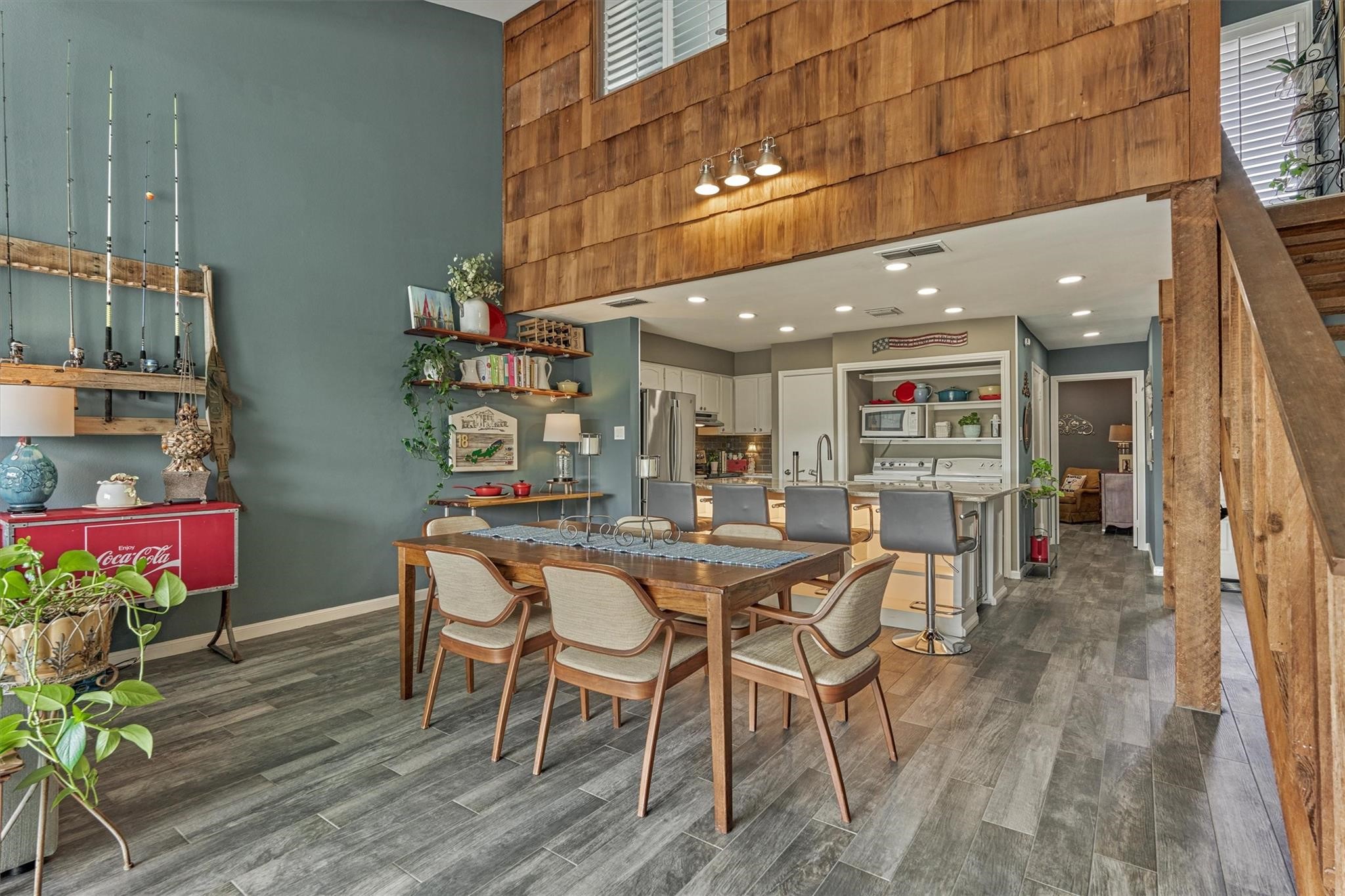 1 April Point Drive South Montgomery, TX 77356 - Photo 10 of 45 A look back at the kitchen and dining area reveals a cedar clad feature wall with coordinating columns and handrail.