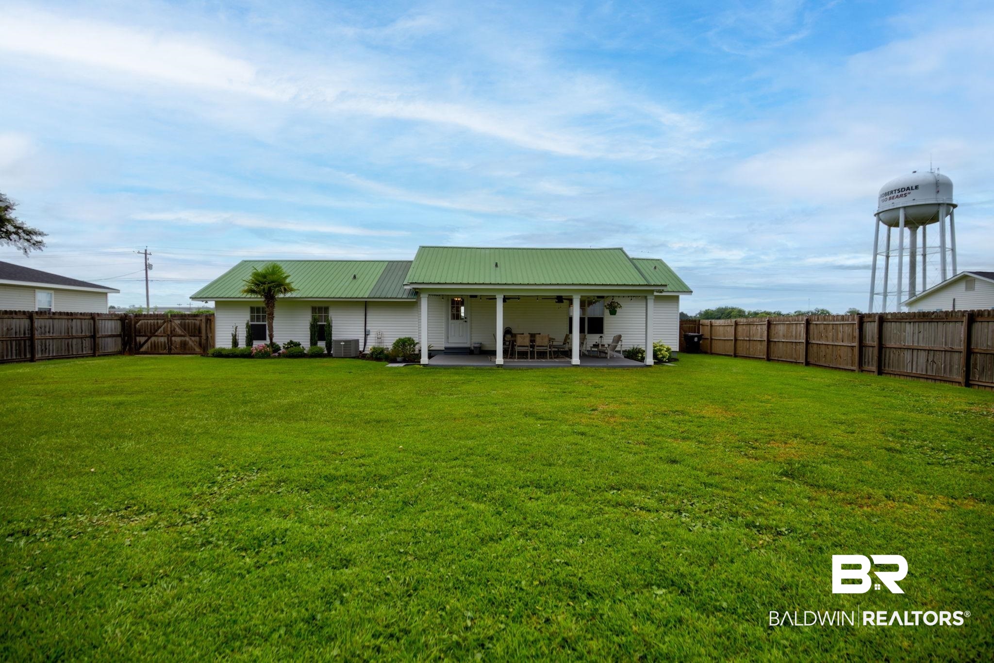 18732 Fairground Road Robertsdale, AL 36567 - Photo 32 of 46 Rear view of property with central AC unit, a patio, and a yard