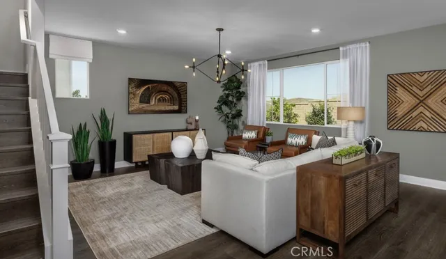 a living room with furniture a window and a chandelier